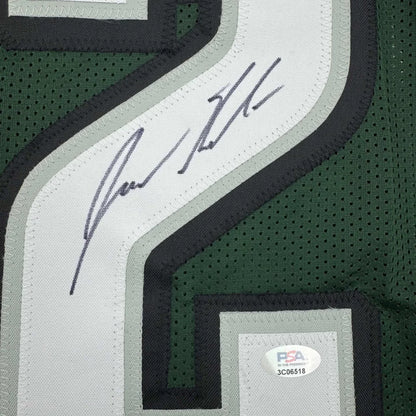 Green and white mesh custom jersey with black trim and signature on sleeve from professional sports league