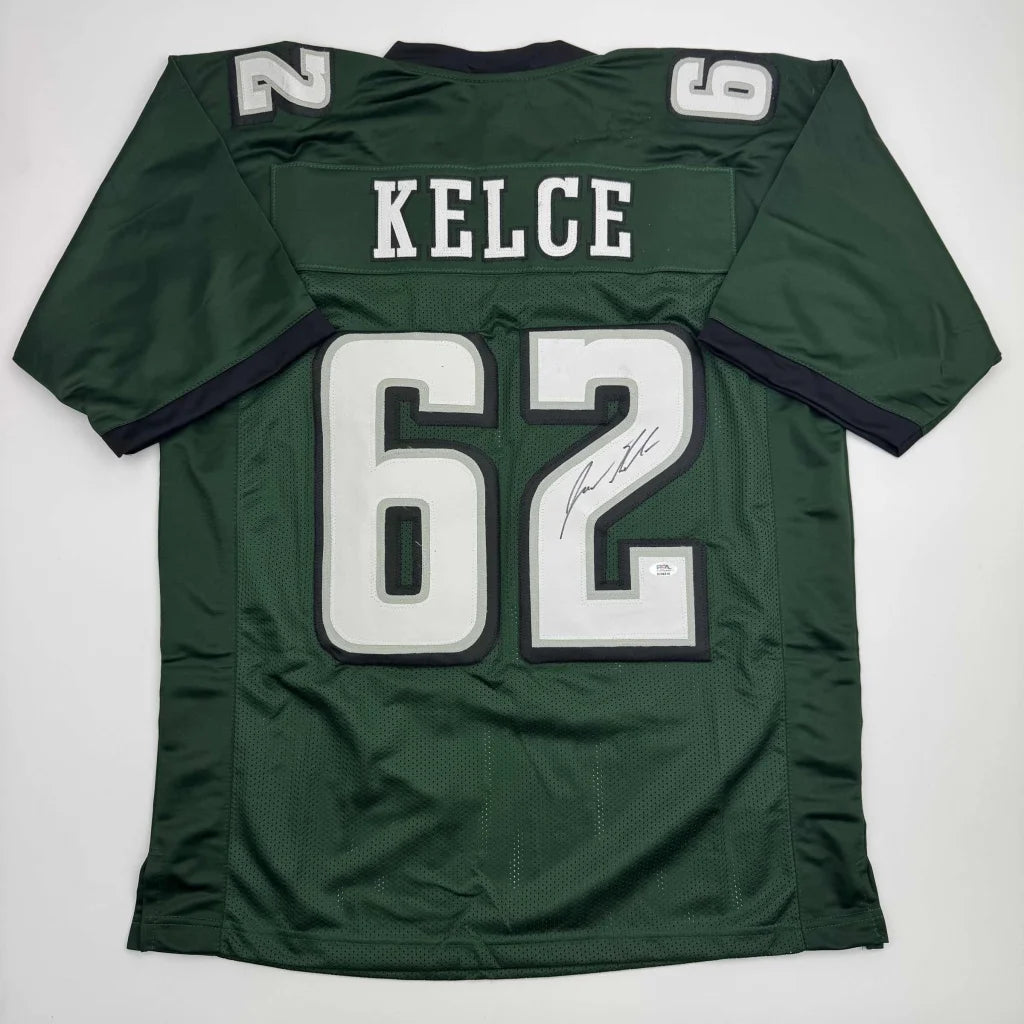 Back of green autographed jason kelce football jersey with white and black lettering custom jersey from professional sports league