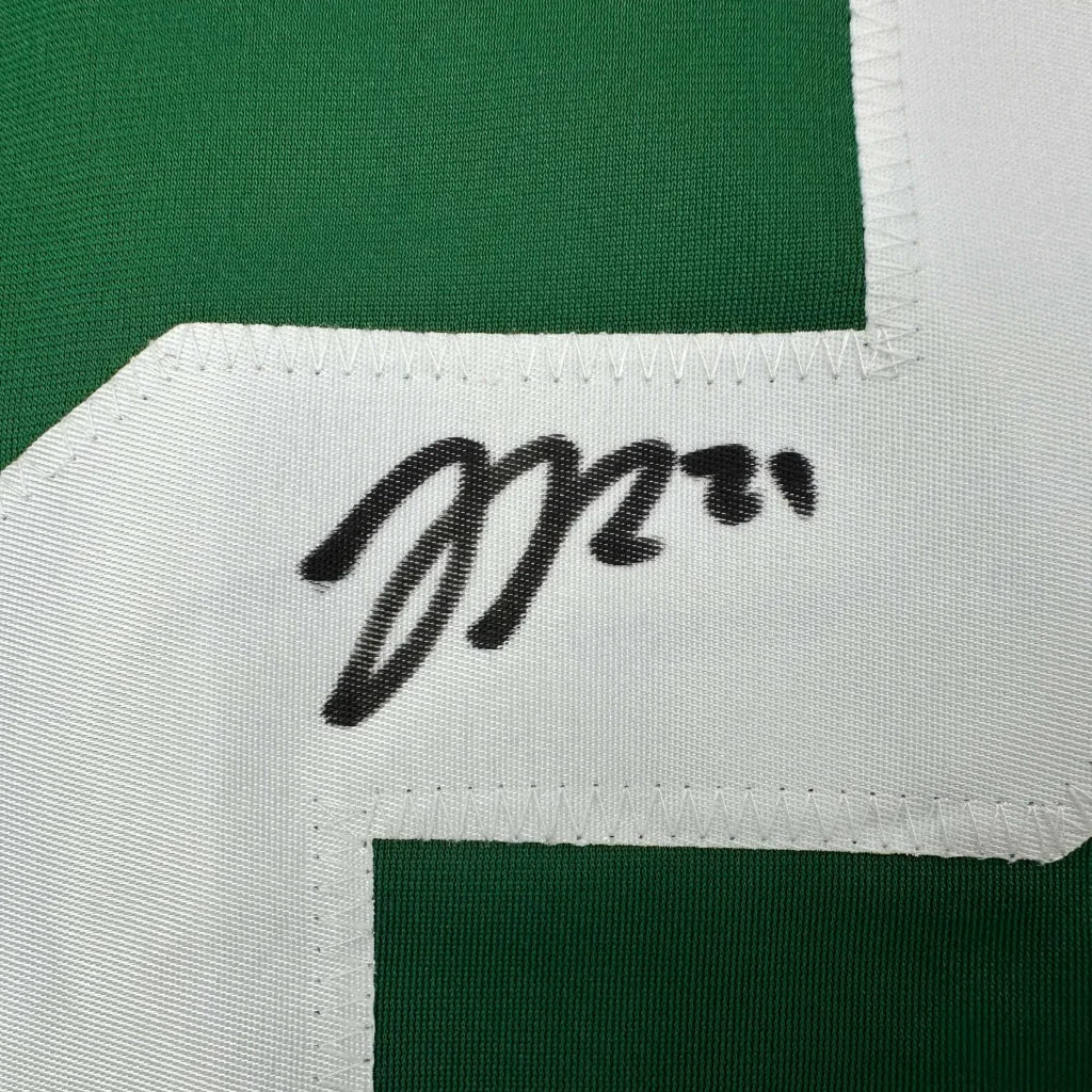 Green and white professional sports league jersey with black marker signature