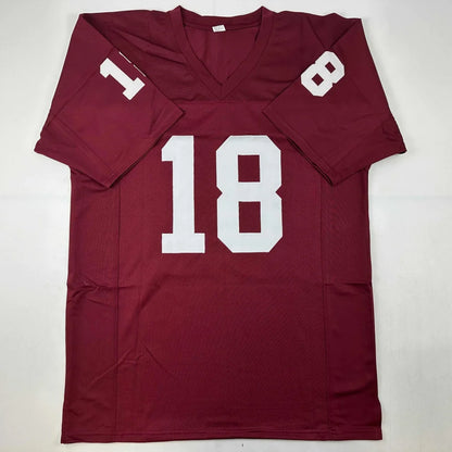 Maroon custom football jersey with white 18 number signed by J White and ED Heuman