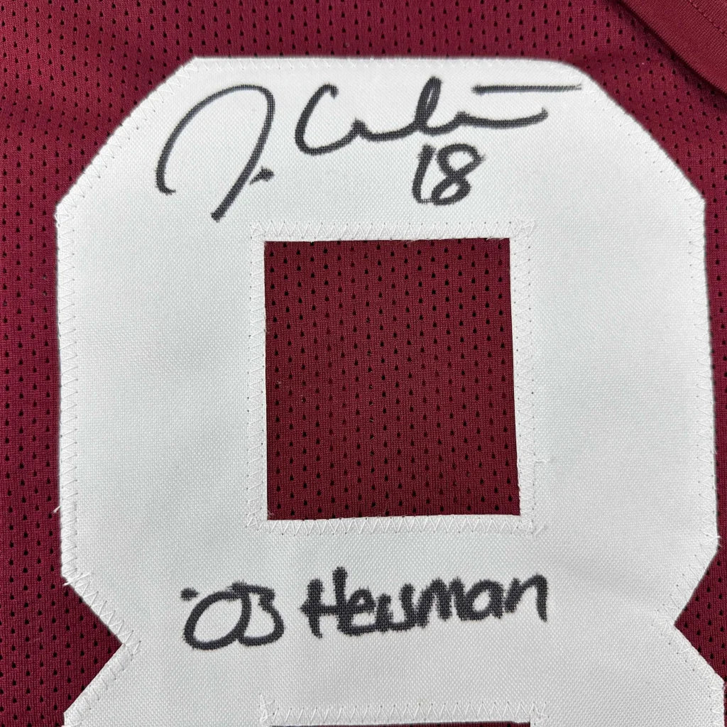 Maroon custom sports jersey with white numbers signed by J White and ED Heuman