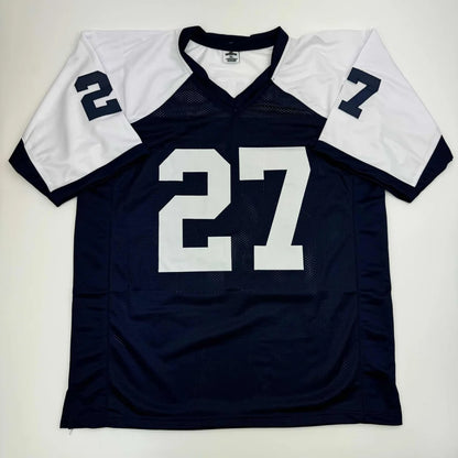 Navy blue and white custom football jersey signed by a professional sports legend