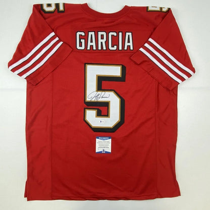 Back of a red san francisco 49ers custom jersey with white gold trim featuring garcia 5 autographed for professional sports league use