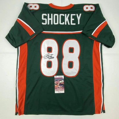 Back of green and orange miami hurricanes custom jersey with white lettering shockey 88 signed for professional sports league fans