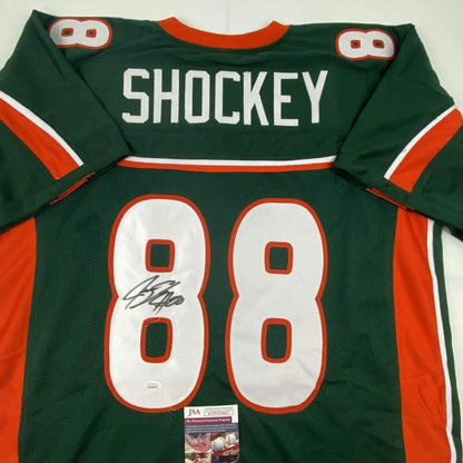Back of green and orange custom jersey with white number 88 and shockey name autographed for professional sports league use
