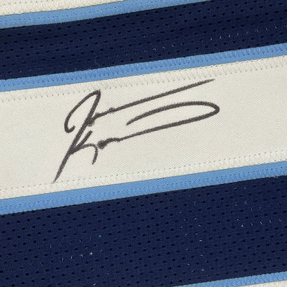 Black signature stitched on white fabric strip bordered by light blue and navy mesh stripes on custom jersey