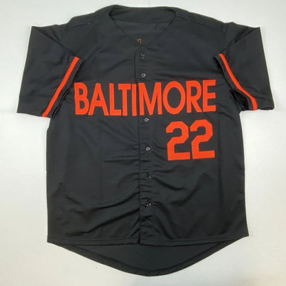Black custom jersey with BALTIMORE 22 and orange stripes, perfect for professional sports fans