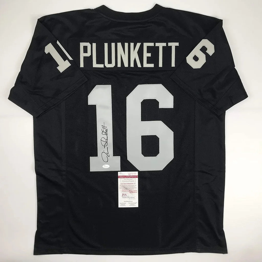 Back of a custom black nfl football jersey with silver lettering plunkett 16 autographed for professional sports display