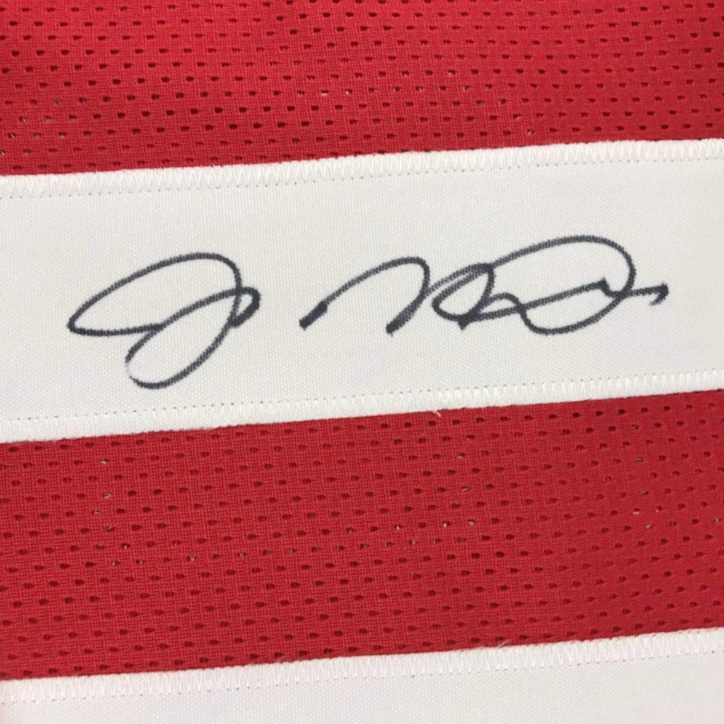 Red mesh custom jersey with white stripe and black autograph from a professional sports legend