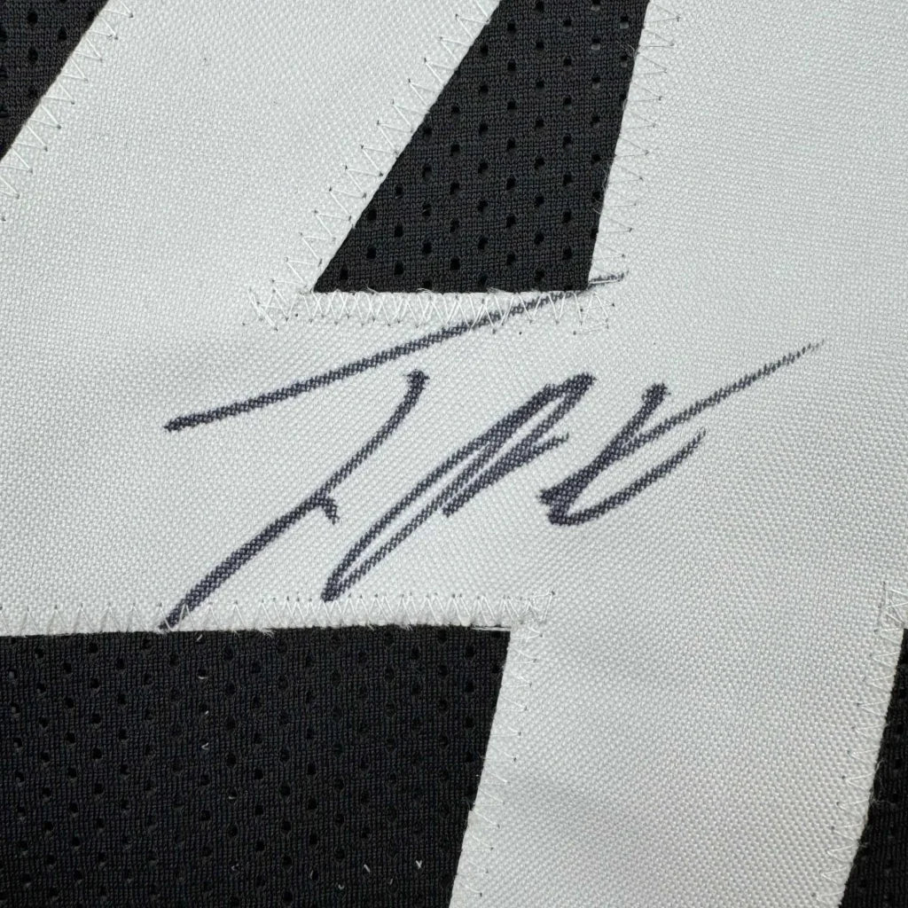 Black and white custom jersey signed by a pro athlete from a sports league