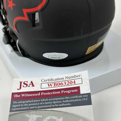 Black Houston Texans mini helmet with red star logo and third party authentication sticker