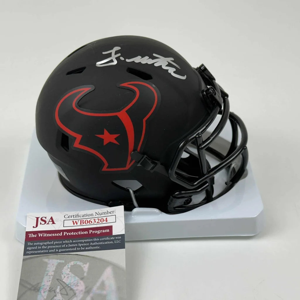Black Houston Texans mini football helmet with silver autograph and third party authentication