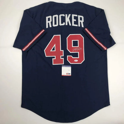 Dark blue professional sports league baseball jersey with signed 49 and Rocker on back