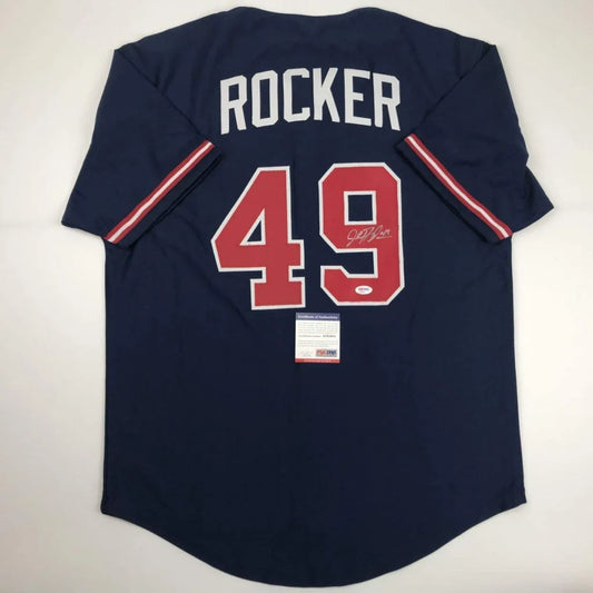 Dark blue professional sports league baseball jersey with signed 49 and Rocker on back