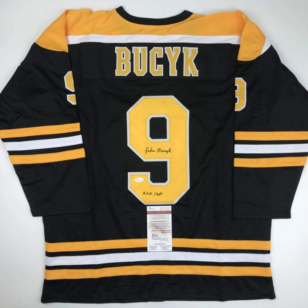 Autographed Johnny Bucyk Boston Bruins custom jersey, black and gold with yellow number 9