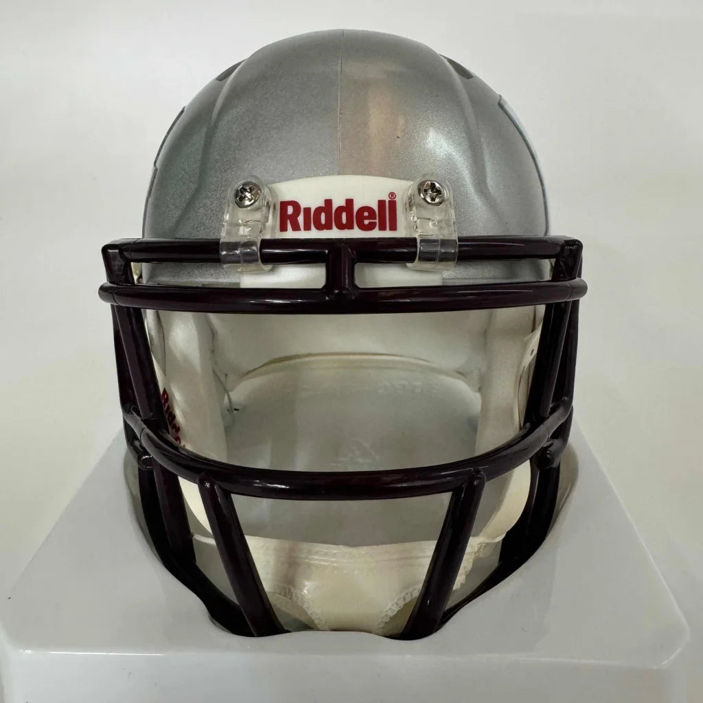 Silver football helmet with dark facemask showcasing third party authentication for Texas A&M