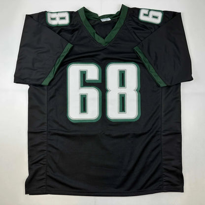 Black and green custom football jersey with number 68 from Rare Mailata in professional sports league