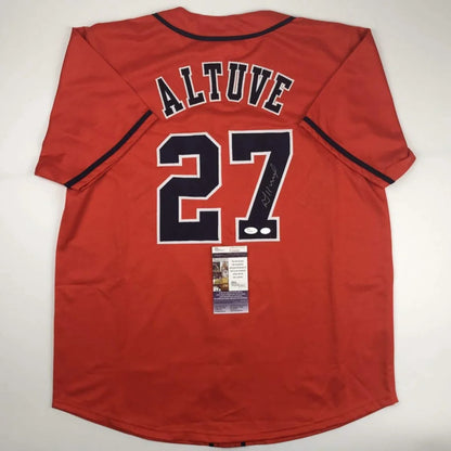Back of a red custom baseball jersey with black lettering altuve 27 signed from professional sports league player