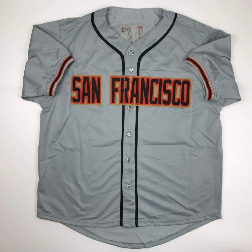 Gray San Francisco custom jersey with black trim and orange-red lettering signed by Juan Marichal for professional sports league use