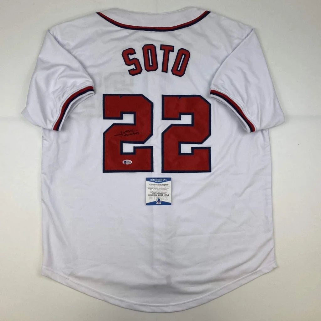 Back of autographed juan soto white baseball custom jersey with red and navy trim and bold red lettering 22 for professional sports league