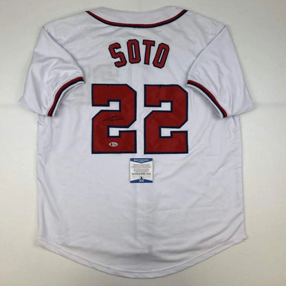 Back of autographed juan soto white baseball custom jersey with red and navy trim and bold red lettering 22 for professional sports league