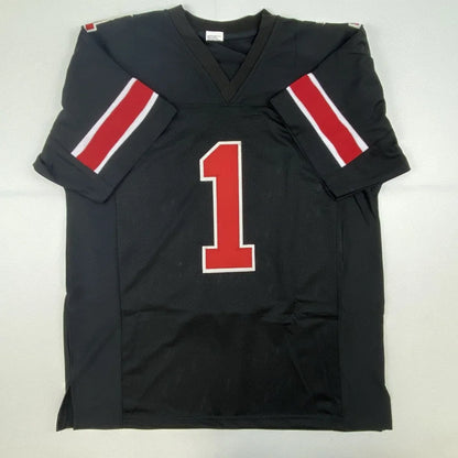 Black autographed Justin Fields Ohio State college football custom jersey with red white sleeve stripes and number one for professional sports league fans