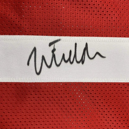 Autographed black ink signature on white stripe of red mesh ohio state football custom jersey for professional sports league