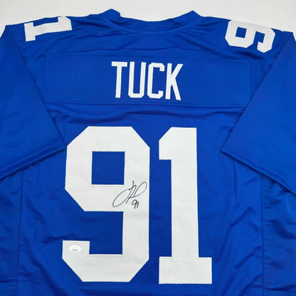 Blue American football jersey signed by a professional sports legend, featuring TUCK 91