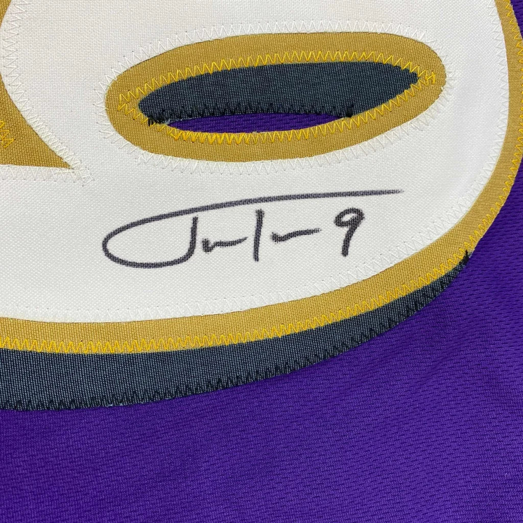 Signed purple custom jersey from a professional sports league with a white, gold, and gray number 9