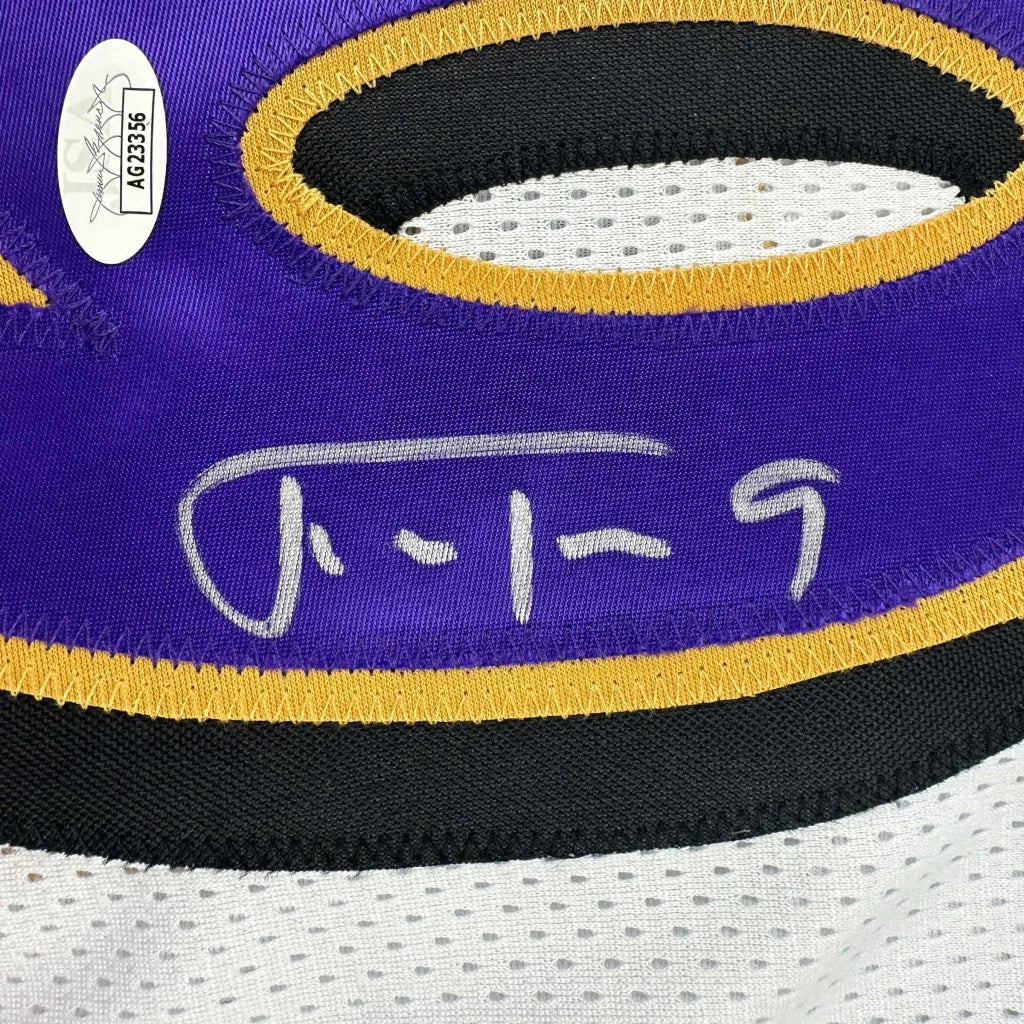 Autographed purple and gold custom jersey from a professional sports league with authenticity sticker