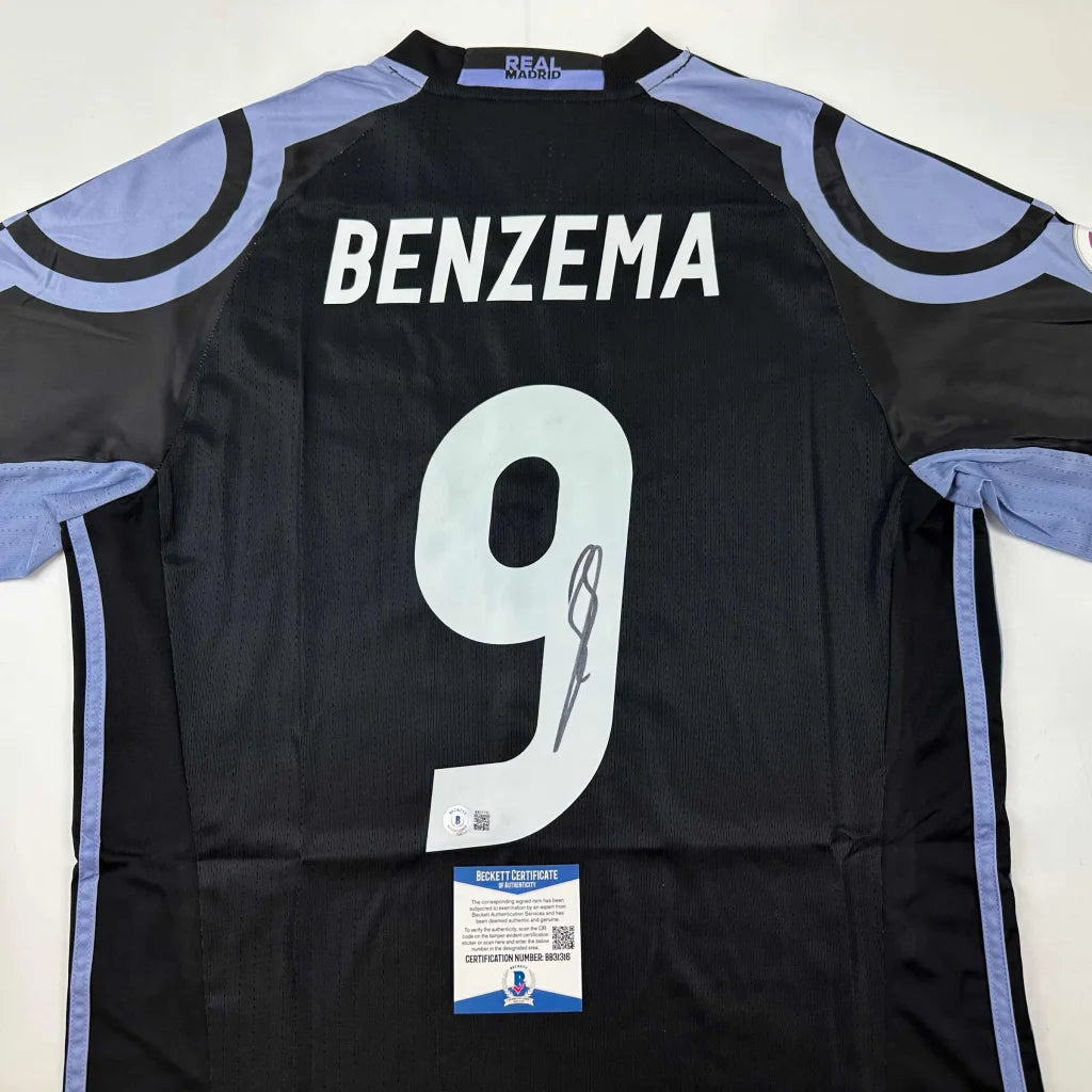 Black Real Madrid custom jersey with Benzema 9 autograph and authenticity sticker from professional sports league