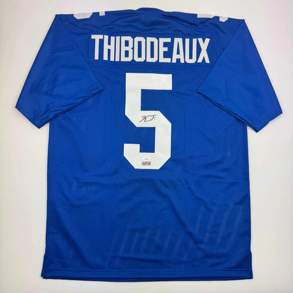 Back view of autographed blue mesh custom jersey with white thibodeaux 5 lettering from professional sports league