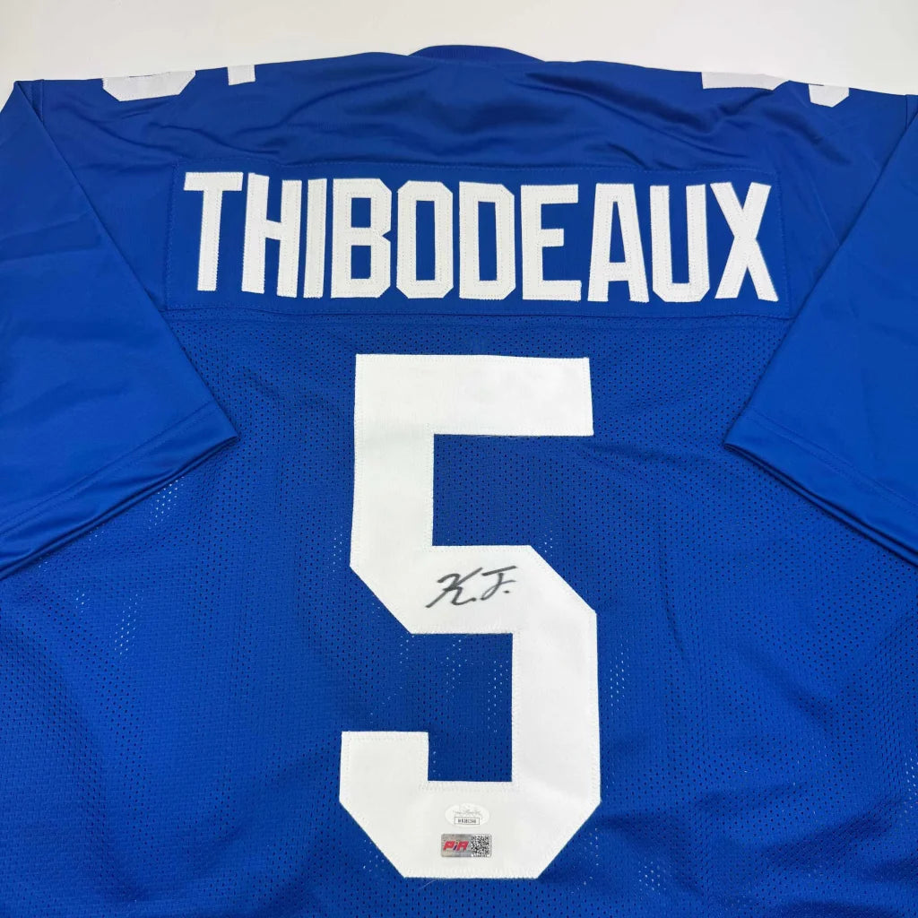 Back of a blue mesh custom football jersey with white lettering number five thibodeaux autograph professional sports league