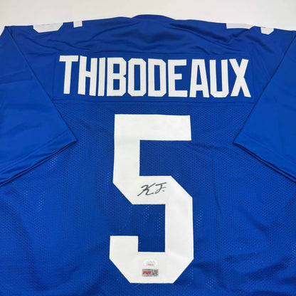 Back of a blue mesh custom football jersey with white lettering number five thibodeaux autograph professional sports league