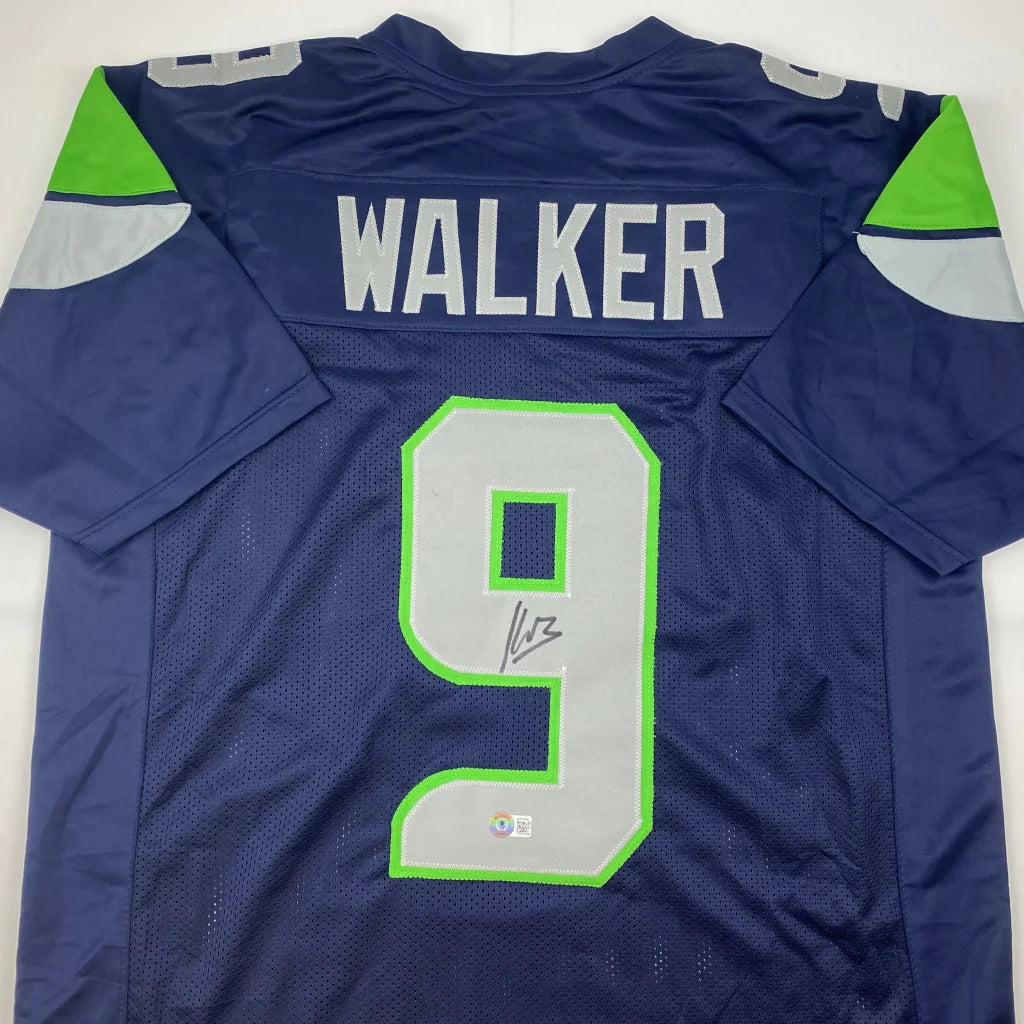 Dark blue custom jersey with green gray accents and autograph from a pro sports league