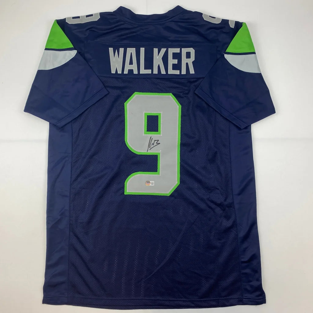 Dark blue custom jersey with gray numbers and green trim from professional sports league