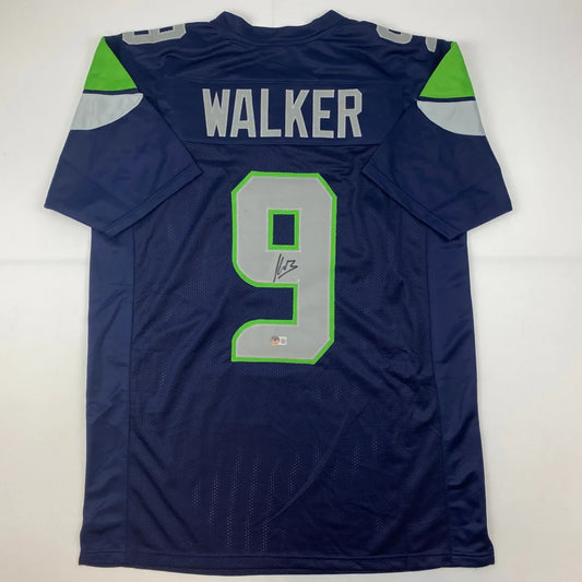 Dark blue custom jersey with gray numbers and green trim from professional sports league