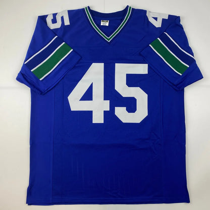 Blue professional sports league custom jersey with white 45 number and green striped sleeves