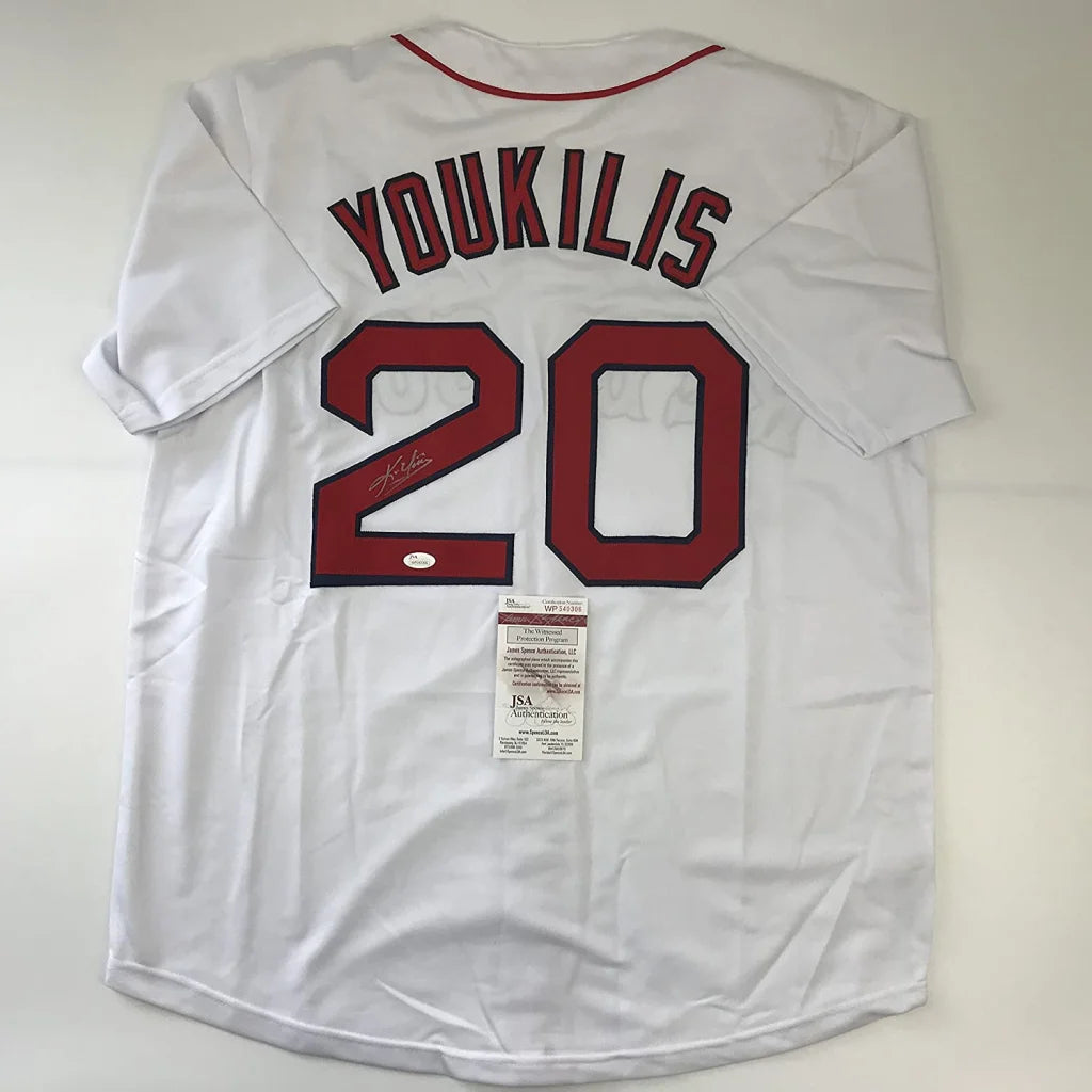 White baseball jersey with red trim and autograph, perfect for professional sports fans