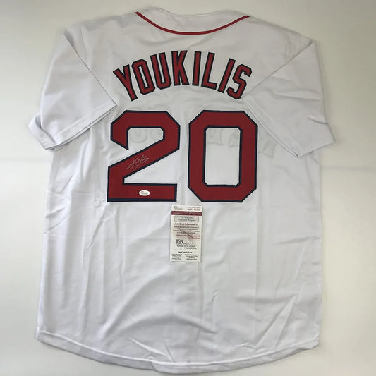 White baseball jersey with red trim and autograph, perfect for professional sports fans