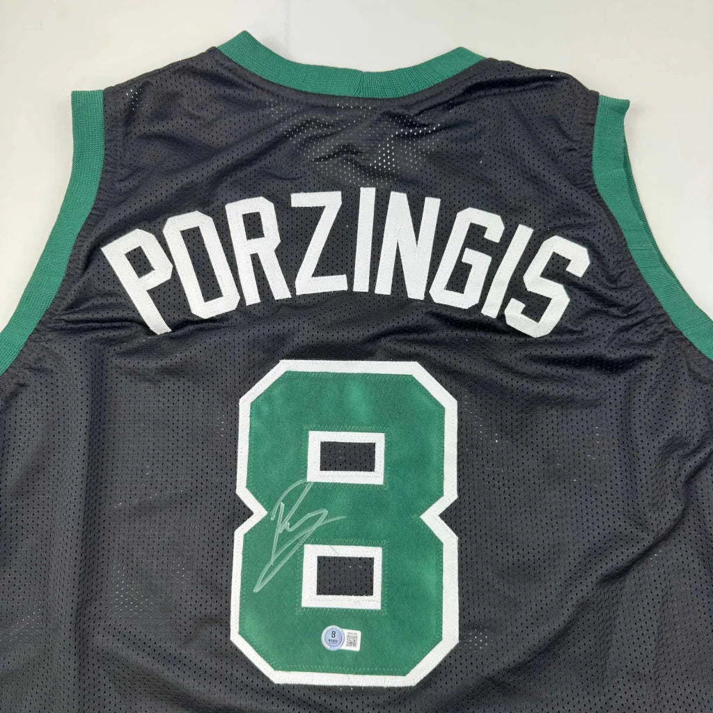 Black mesh Porzingis custom jersey with green trim, signed, for professional sports fans