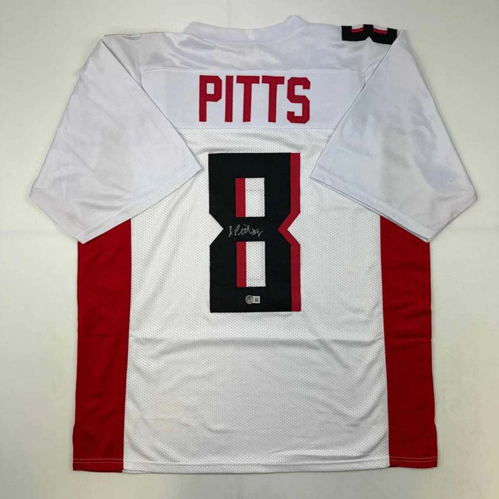 Back of autographed kyle pitts atlanta white football custom jersey with red black accents from professional sports league