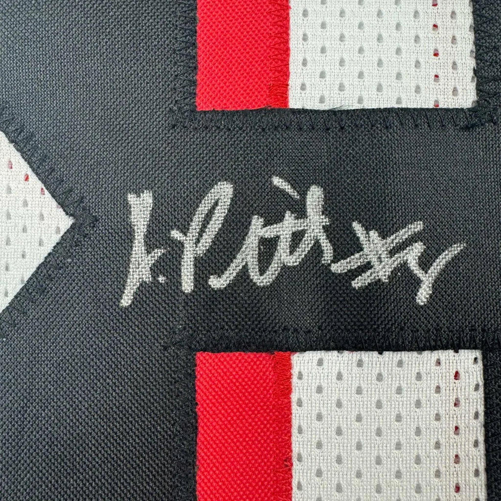 Black and red mesh fabric patch with white embroidered signature on custom kyle pitts atlanta football jersey for professional sports league