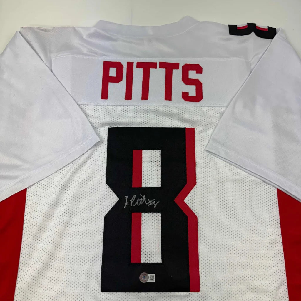 Back of a white kyle pitts autographed football jersey with red and black accents custom jersey from professional sports league