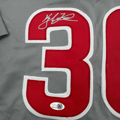 Gray custom jersey from a professional sports league with red number 3 and autograph