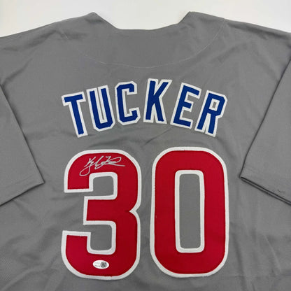 Gray custom jersey from a professional sports league with blue and red numbers