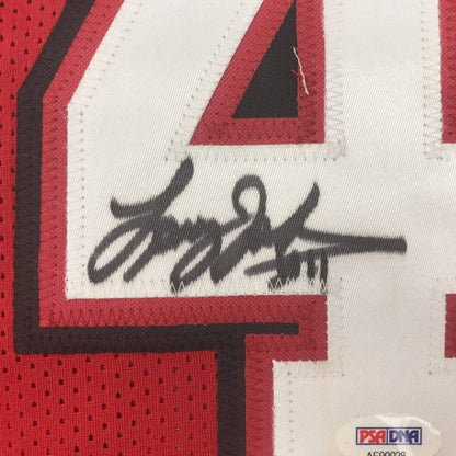 Autographed red and white custom jersey from a professional sports league with PSA DNA sticker