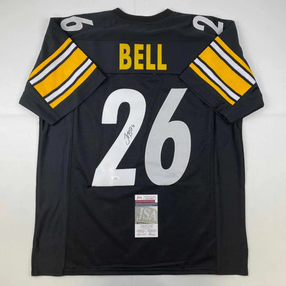 Black Pittsburgh Steelers custom jersey with Bell 26 autograph and JSA sticker from professional sports league
