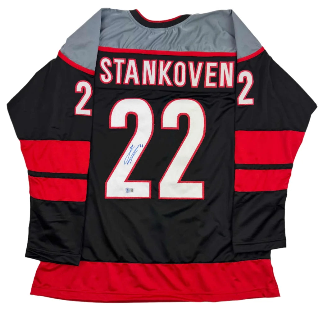Autographed Logan Stankoven custom jersey in black with red accents, number 22