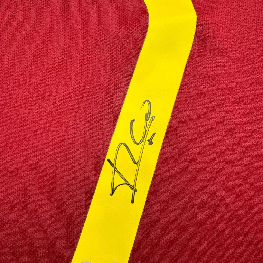 Red fabric with yellow strap and black signature on custom jersey for professional sports league